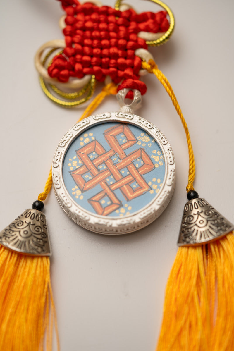 Tassel-Adorned Endless Knot Locket