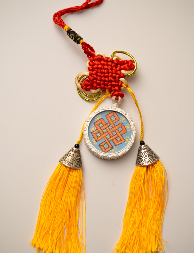 Tassel-Adorned Endless Knot Locket