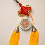 Tassel-Adorned Endless Knot Locket