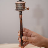 Wood handle prayer wheel for spiritual and religious routines.