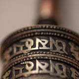 Wood handle prayer wheel for spiritual and religious routines.