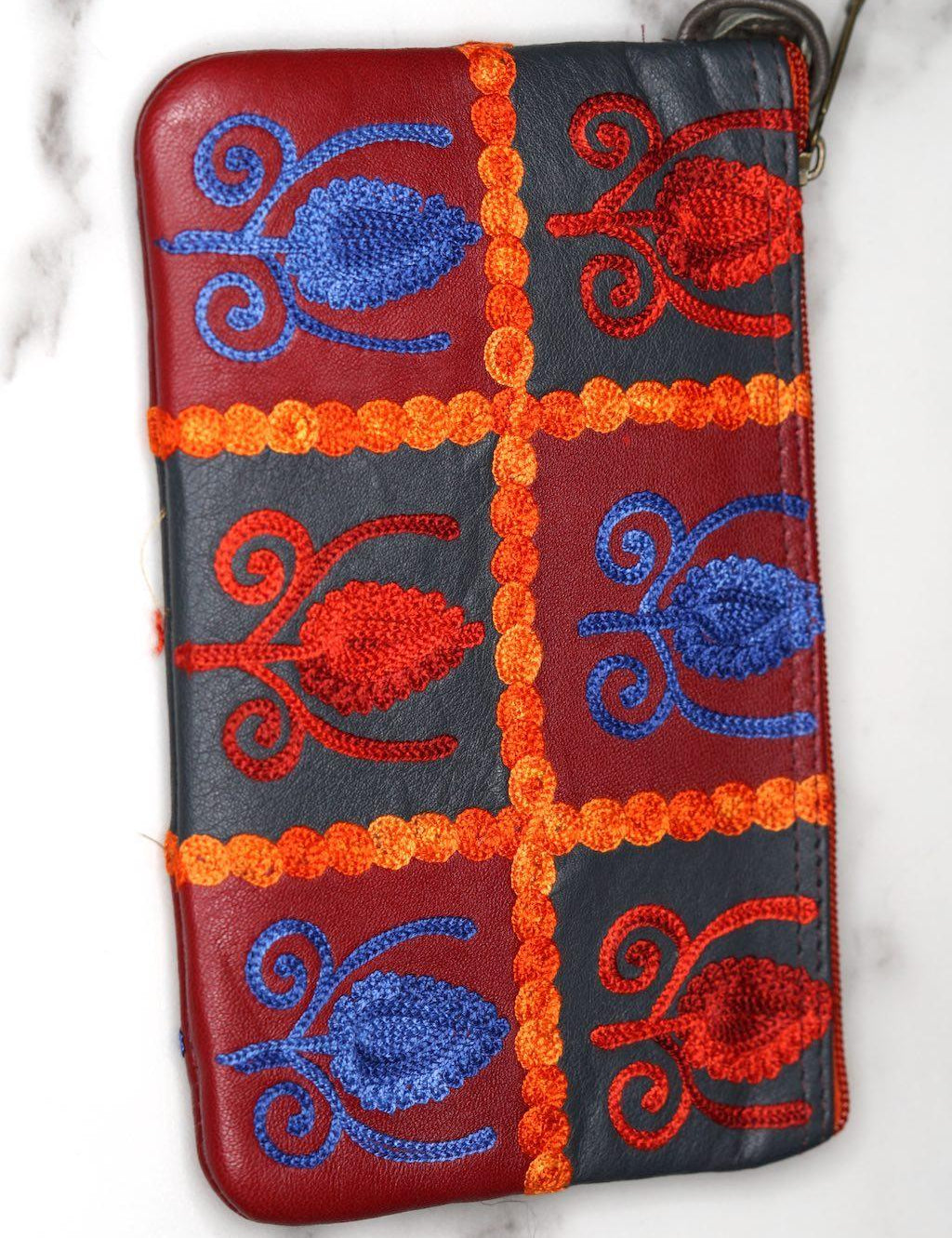 Vibrant colorful purse with kashmiri hand embroidery, has a secure zip top closure, ethically made in Nepal.