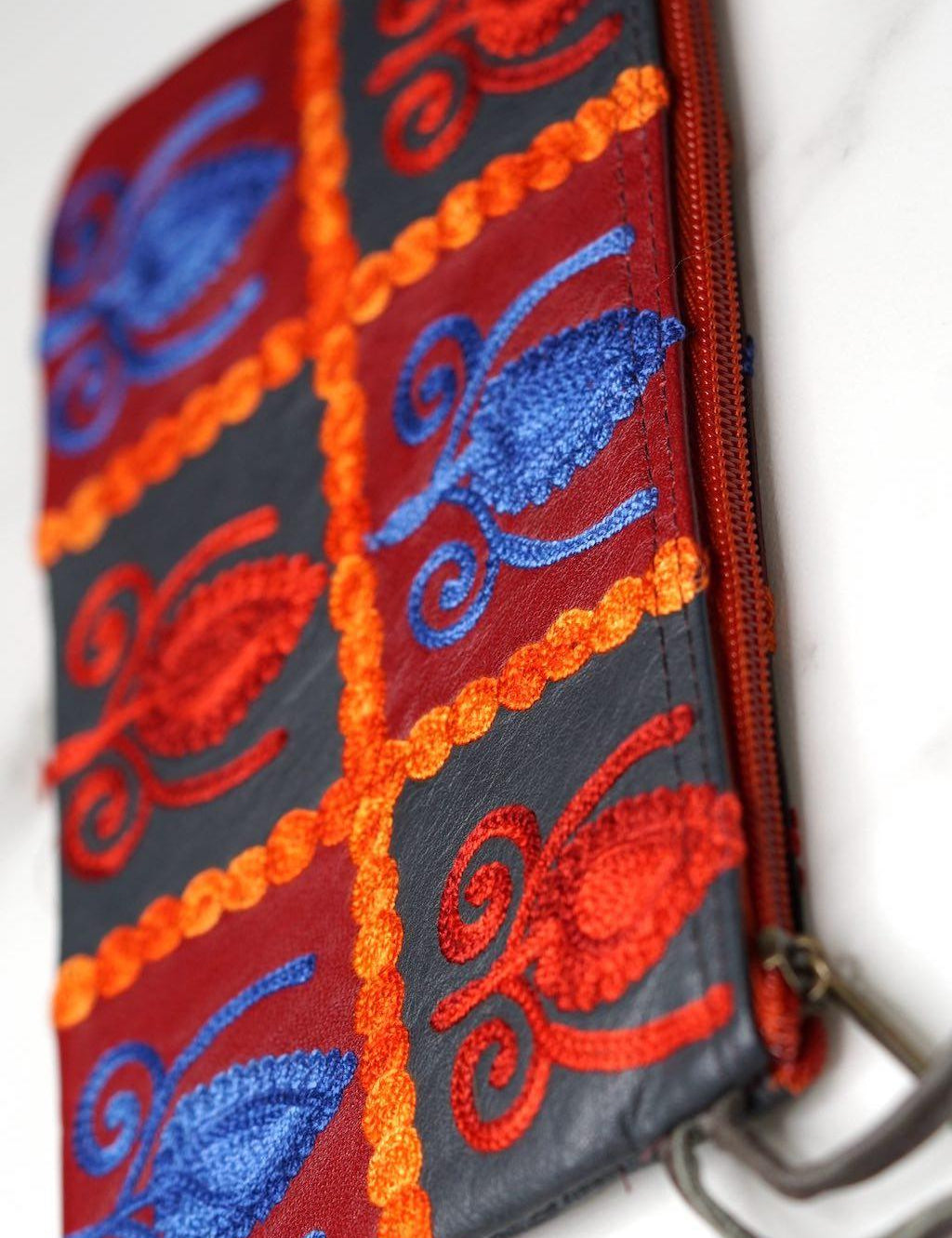 Vibrant colorful purse with kashmiri hand embroidery, has a secure zip top closure, ethically made in Nepal.