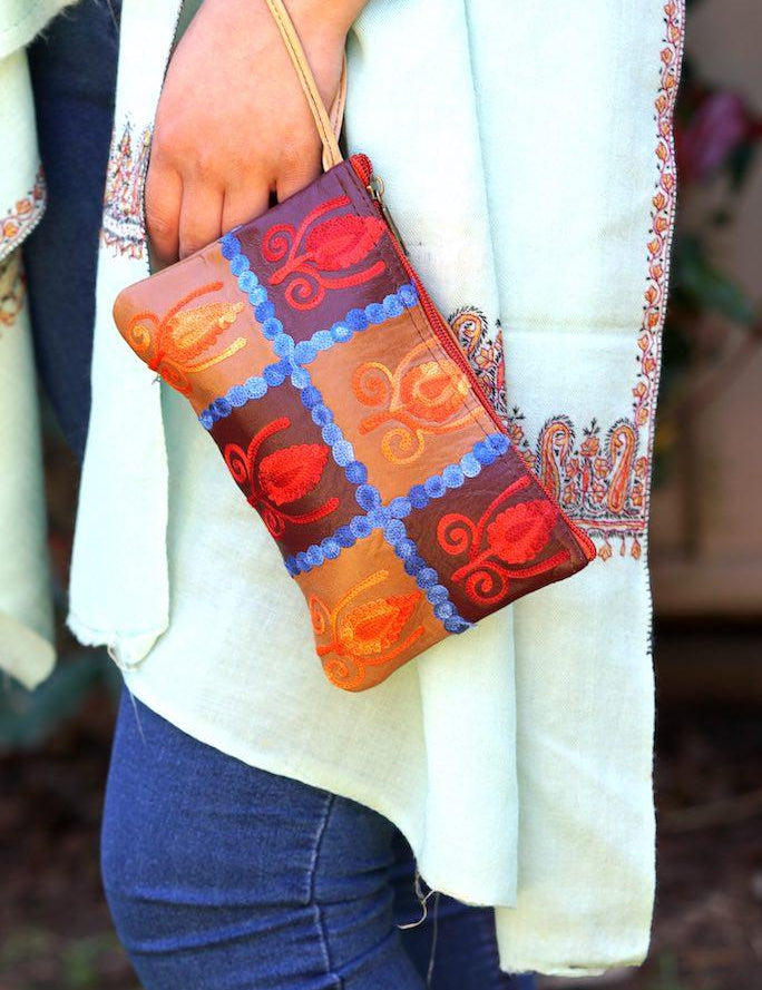 Vibrant colorful purse with kashmiri hand embroidery, has a secure zip top closure, ethically made in Nepal.