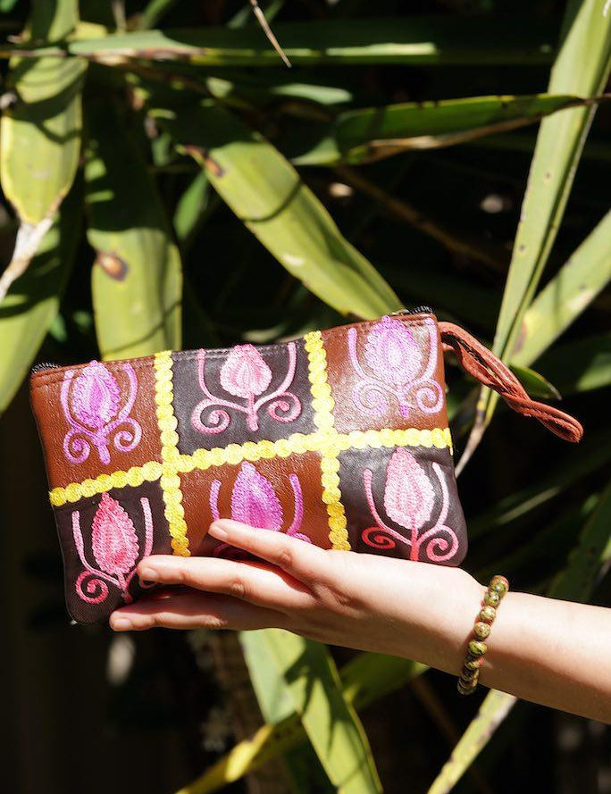 Vibrant colorful purse with kashmiri hand embroidery, has a secure zip top closure, ethically made in Nepal.