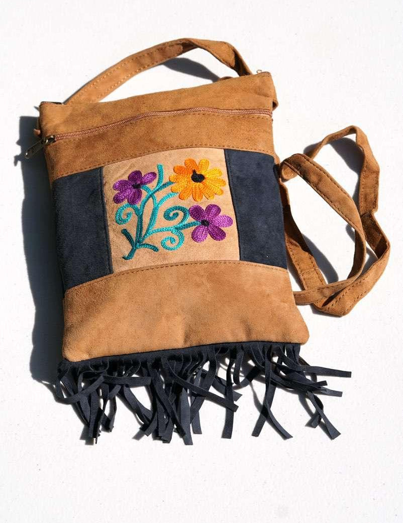 Easy to carry side bag for women, features a beautiful hand embroidered floral pattern. 