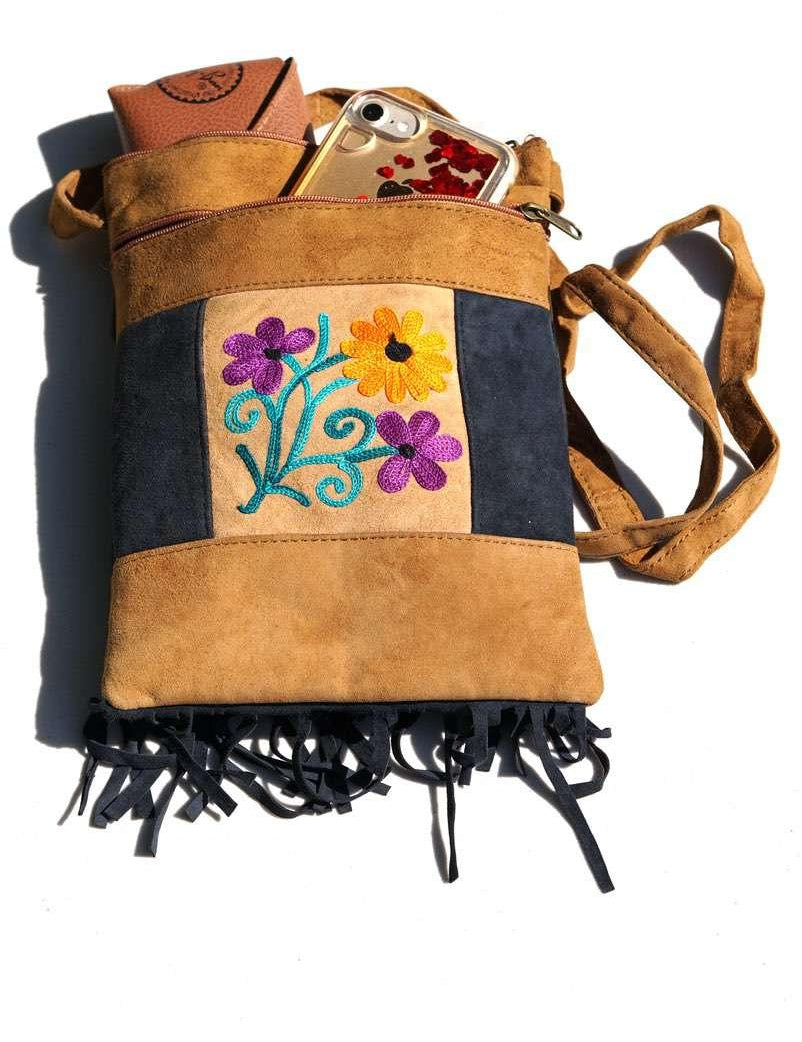 Easy to carry side bag for women, features a beautiful hand embroidered floral pattern. 