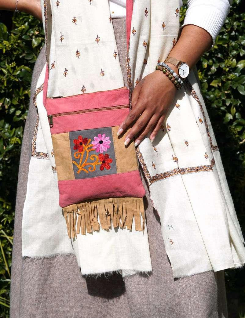 Easy to carry side bag for women, features a beautiful hand embroidered floral pattern. 