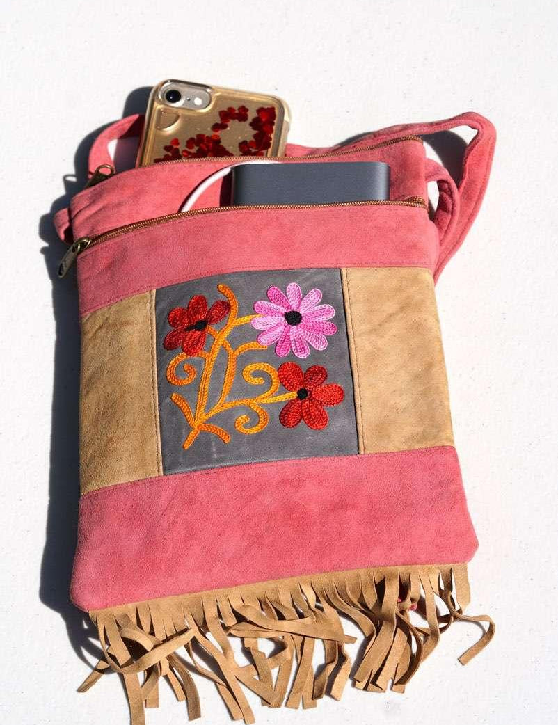 Easy to carry side bag for women, features a beautiful hand embroidered floral pattern. 