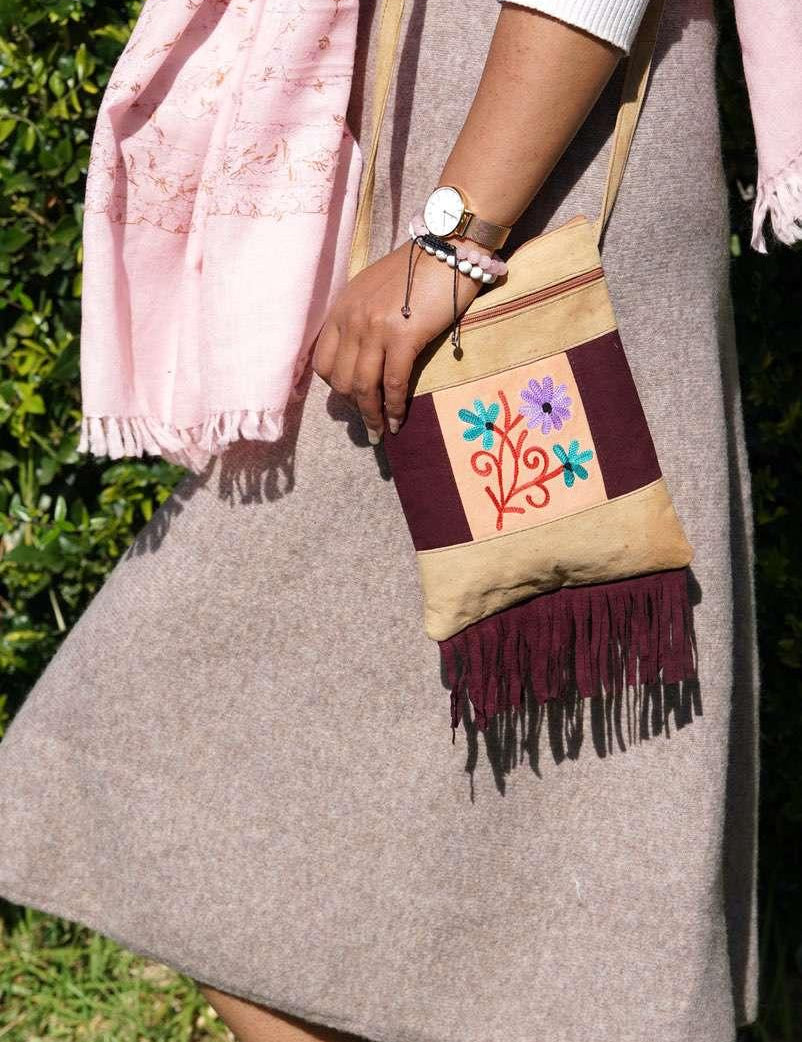 Easy to carry side bag for women, features a beautiful hand embroidered floral pattern. 