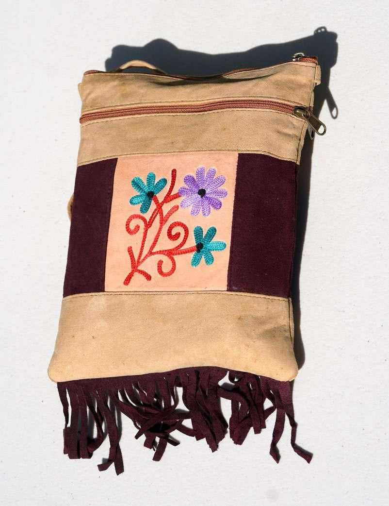 Easy to carry side bag for women, features a beautiful hand embroidered floral pattern. 