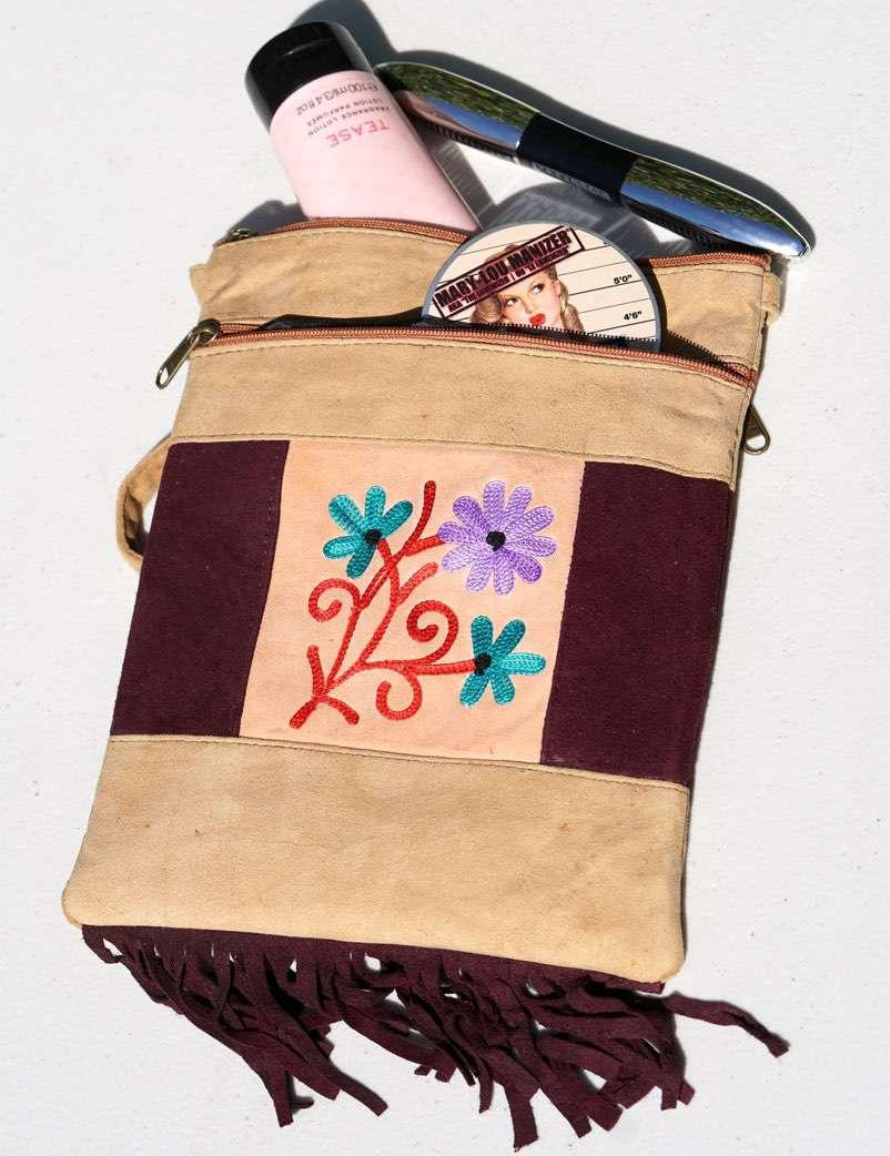 Easy to carry side bag for women, features a beautiful hand embroidered floral pattern. 