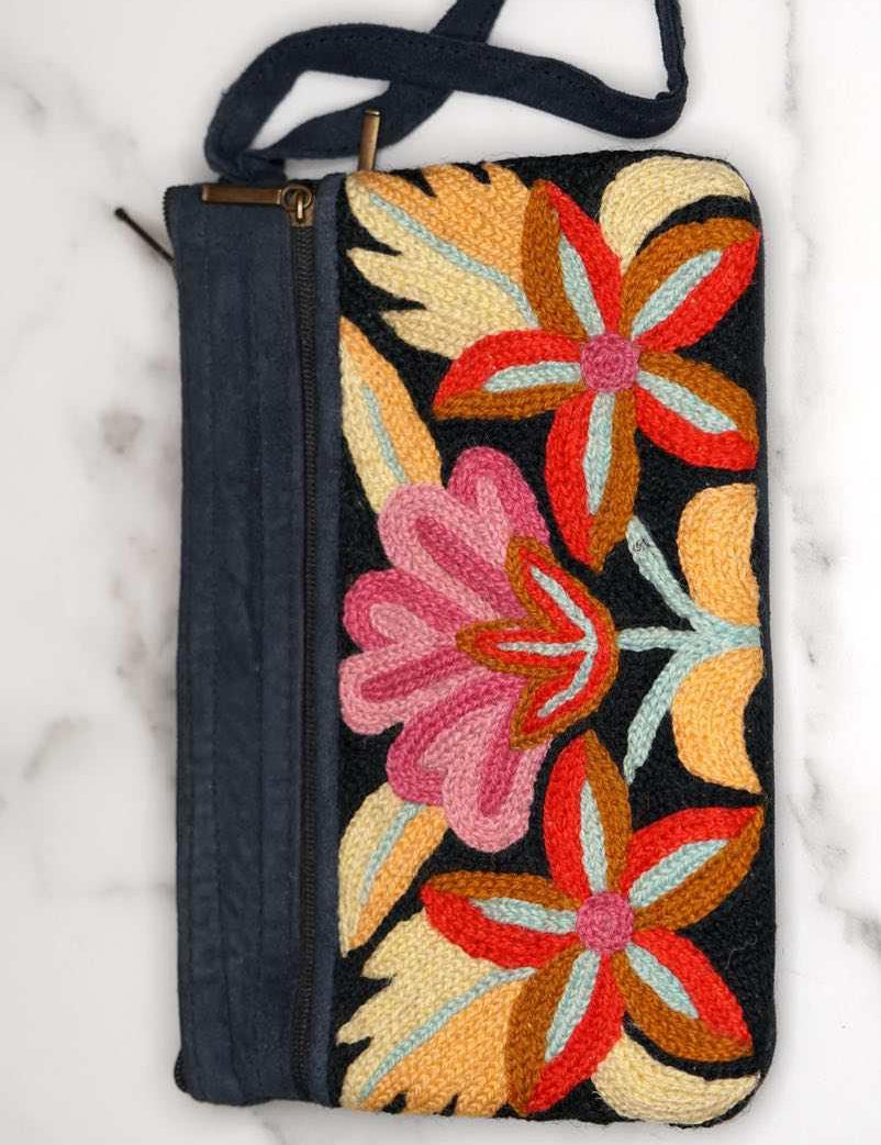 A stylish yet convenient hand woven wristlet purse with beautiful floral pattern, It has a secure zip top closure and two extra compartments for your everyday essentials making it easy to travel simple and light.