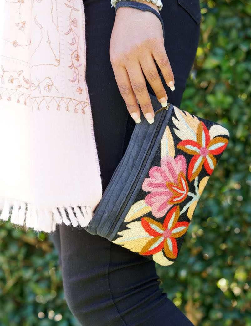 A stylish yet convenient hand woven wristlet purse with beautiful floral pattern, It has a secure zip top closure and two extra compartments for your everyday essentials making it easy to travel simple and light.