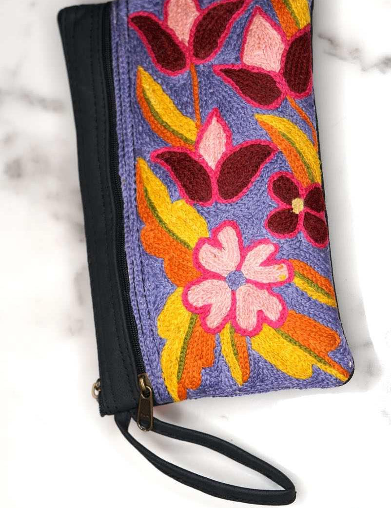 Beautiful flower pattern woman's purse that features a wristlet and secure zip top closure.