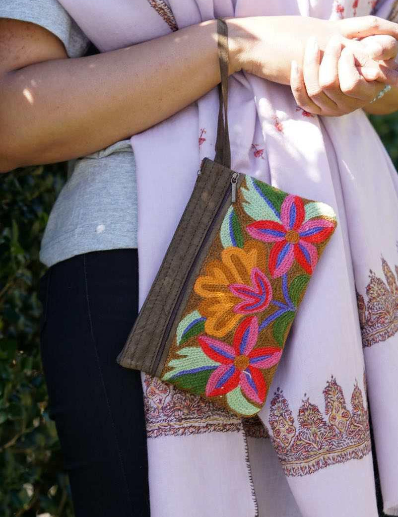 A stylish yet convenient hand woven wristlet purse with beautiful floral pattern, It has a secure zip top closure and two extra compartments for your everyday essentials making it easy to travel simple and light.