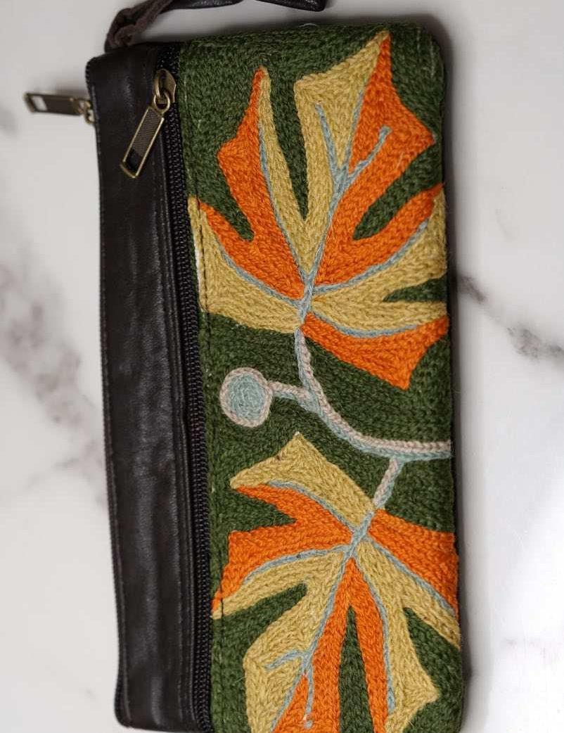 A beautifully hand-embroidered purse with a wristlet and a secure zip top closure. Perfect gift for your loved ones!