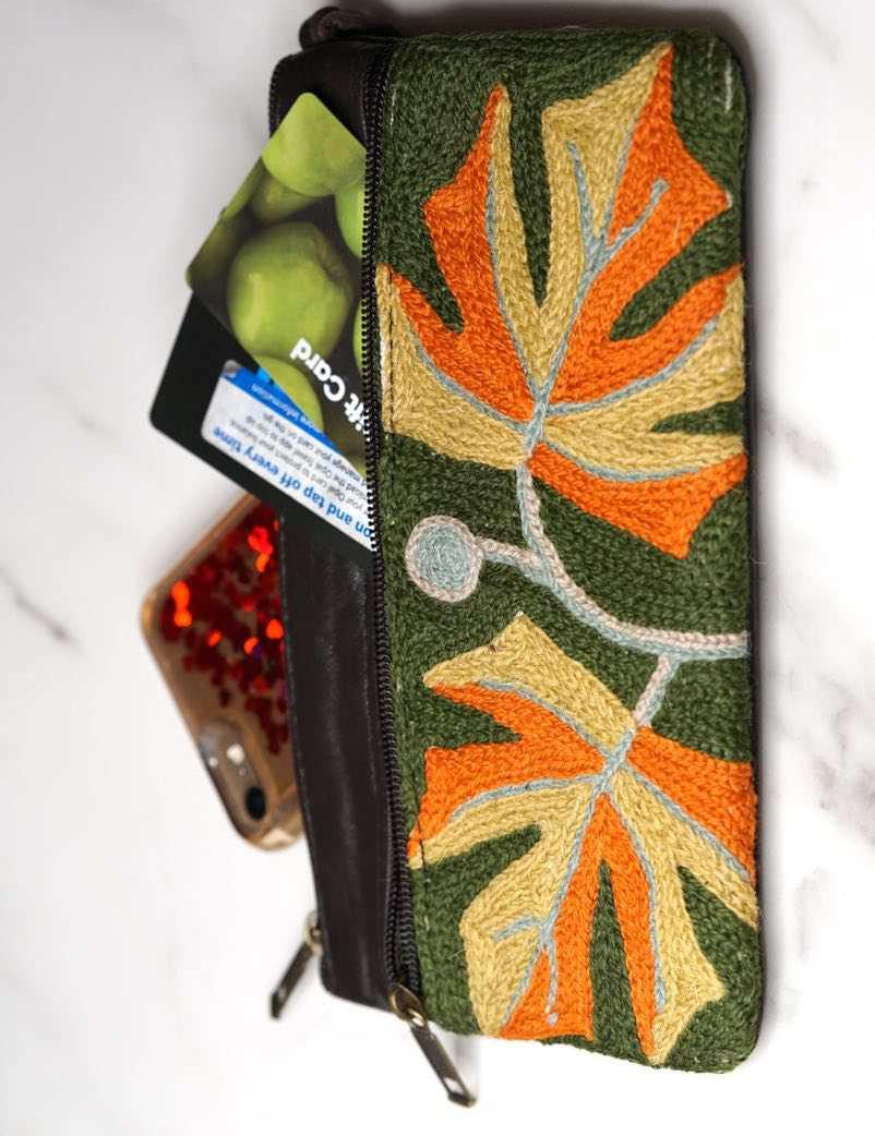 A beautifully hand-embroidered purse with a wristlet and a secure zip top closure. Perfect gift for your loved ones!