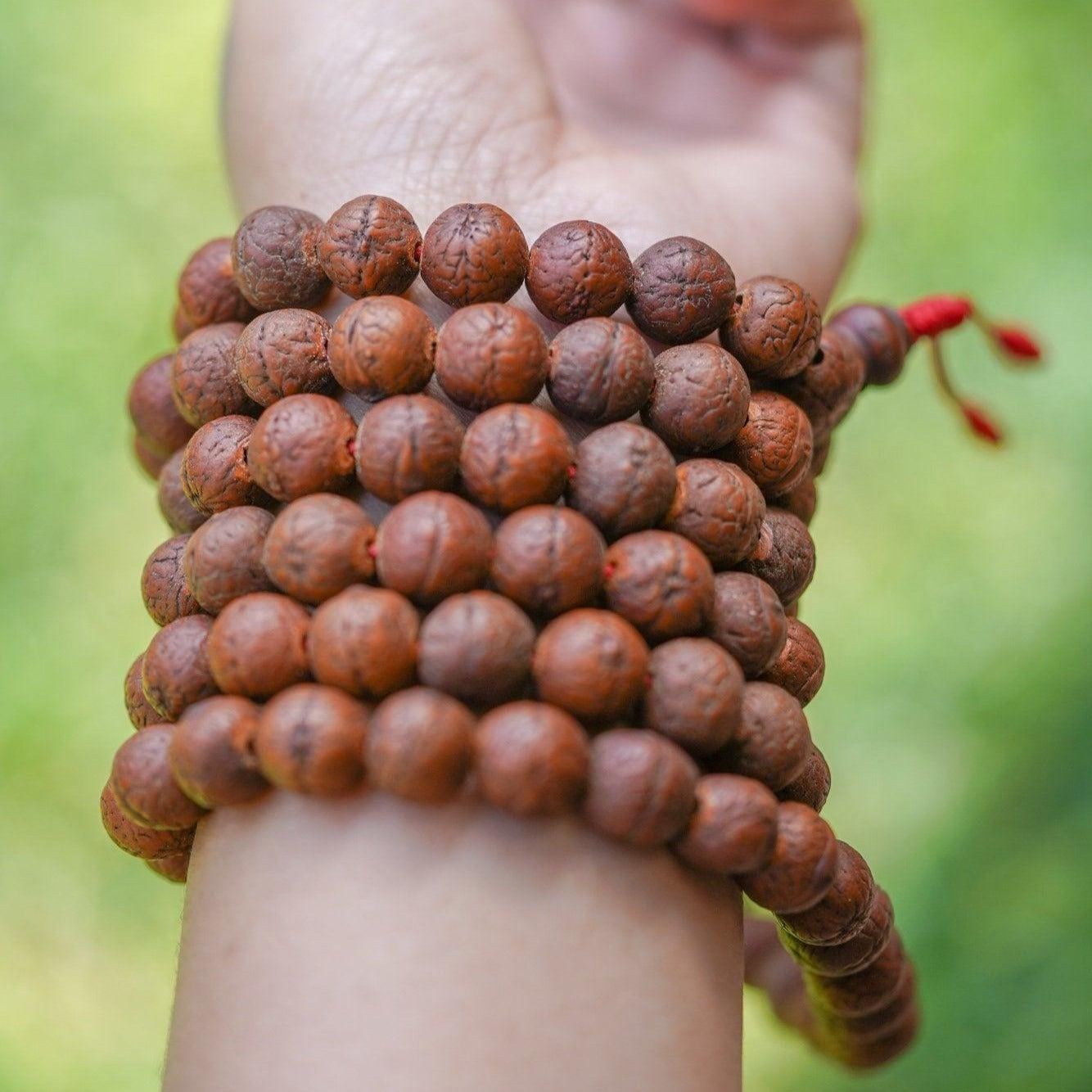 Antique Dark Bodhi Bead Mala being worn around 